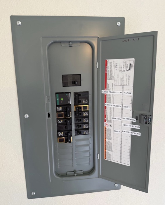 New upgraded electrical panel with labeled circuits and surge protection