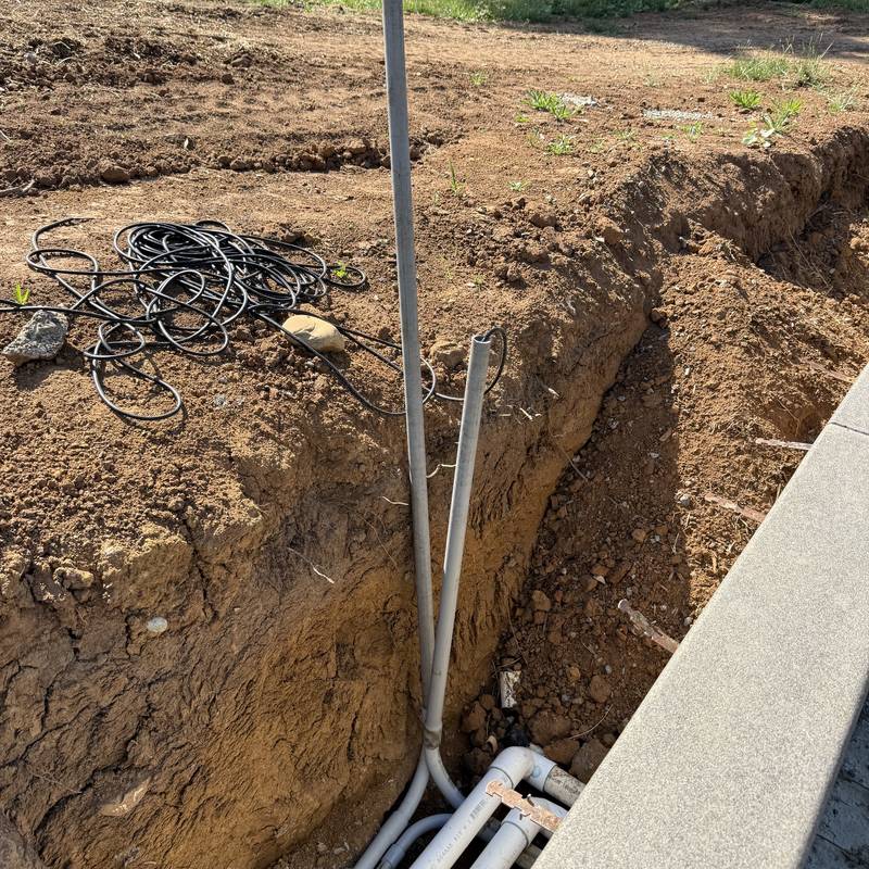 Underground electrical conduit laid in a trench at a new construction site